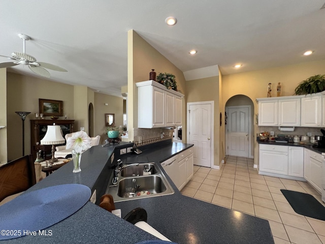 7473 Balmore Dr SW, Sunset Beach, NC 28468 - kitchen featuring arched walkways, light tile patterned flooring, ceiling fan, tasteful backsplash, and recessed lighting