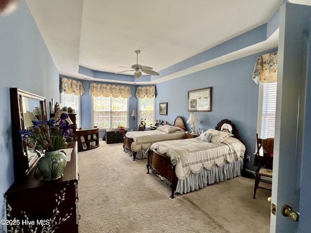 7473 Balmore Dr SW, Sunset Beach, NC 28468 - carpeted bedroom featuring a raised ceiling and a ceiling fan