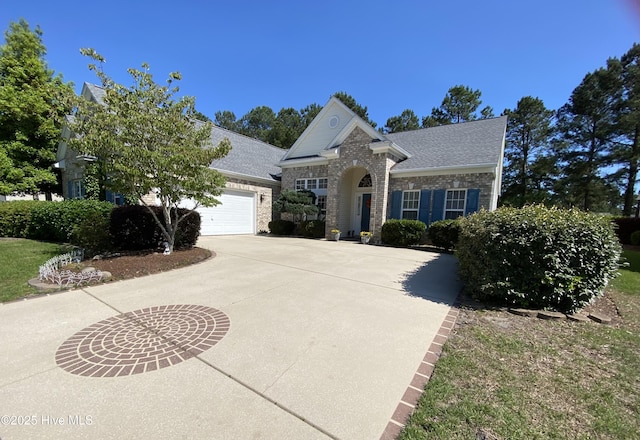 7473 Balmore Dr SW, Sunset Beach, NC 28468 - traditional-style house with driveway, a garage, brick siding, and a shingled roof