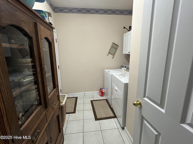 7473 Balmore Dr SW, Sunset Beach, NC 28468 - laundry area featuring cabinet space, light tile patterned floors, washing machine and dryer, and baseboards