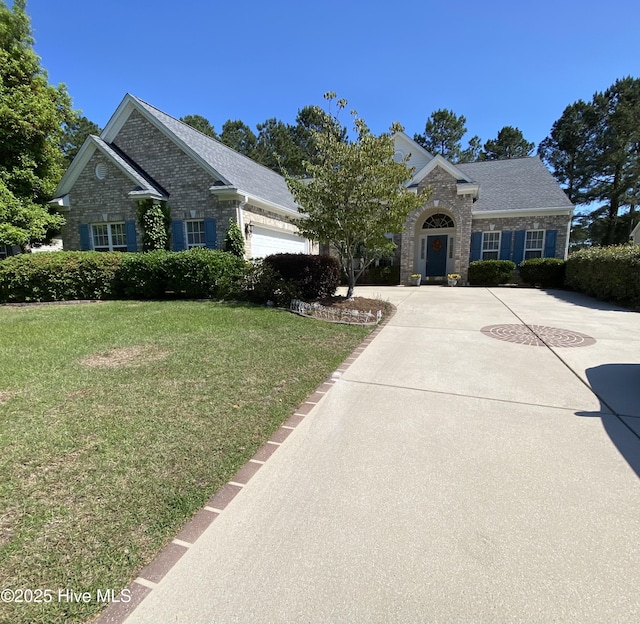 7473 Balmore Dr SW, Sunset Beach, NC 28468 - view of front of home featuring a front yard, an attached garage, concrete driveway, and roof with shingles