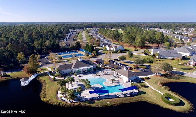 7473 Balmore Dr SW, Sunset Beach, NC 28468 - view of property location with a pool area, nearby suburban area, a large body of water, and a heavily wooded area