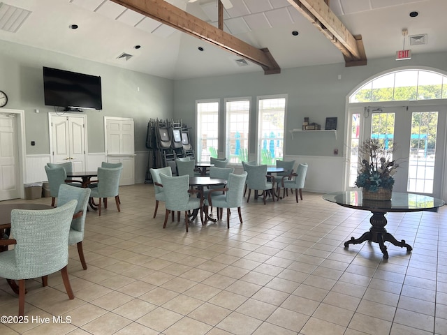 7473 Balmore Dr SW, Sunset Beach, NC 28468 - dining room featuring beamed ceiling, wainscoting, high vaulted ceiling, and light tile patterned flooring