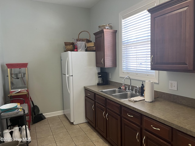 7473 Balmore Dr SW, Sunset Beach, NC 28468 - kitchen with a sink, light tile patterned flooring, and freestanding refrigerator