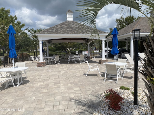 7473 Balmore Dr SW, Sunset Beach, NC 28468 - view of patio / terrace featuring a gazebo and outdoor dining space