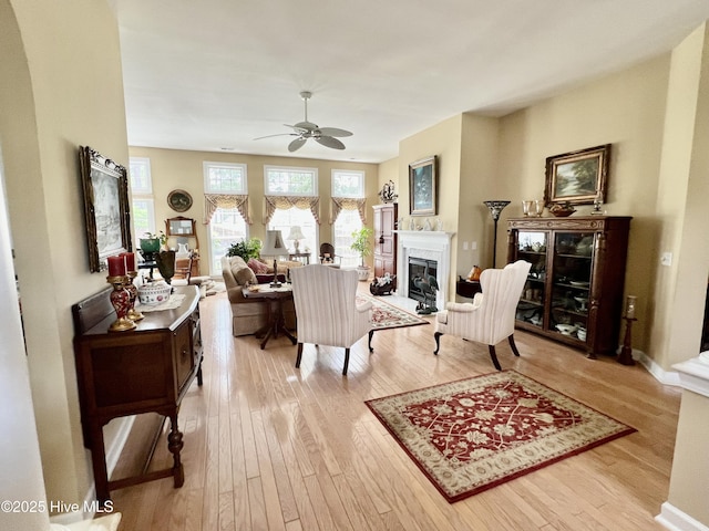7473 Balmore Dr SW, Sunset Beach, NC 28468 - living area with hardwood / wood-style flooring, ceiling fan, a glass covered fireplace, and baseboards