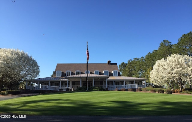 7473 Balmore Dr SW, Sunset Beach, NC 28468 - back of house with a yard, covered porch, and a standing seam roof