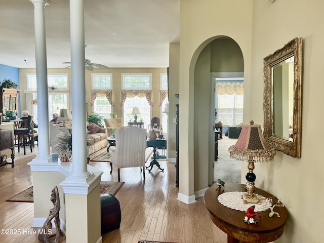 7473 Balmore Dr SW, Sunset Beach, NC 28468 - living area featuring decorative columns, healthy amount of natural light, and hardwood / wood-style flooring