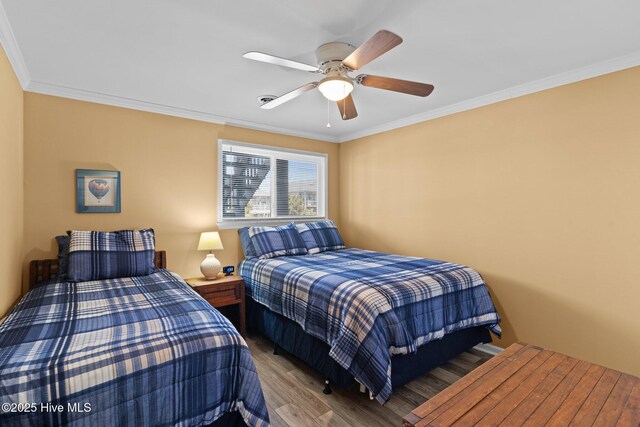 2714 W Beach Dr # 104, Oak Island, NC 28465 - bedroom with a ceiling fan, wood finished floors, and ornamental molding