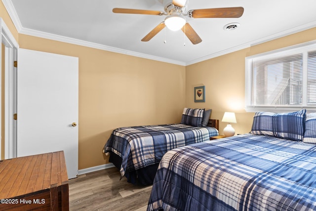 2714 W Beach Dr # 104, Oak Island, NC 28465 - bedroom with visible vents, baseboards, wood finished floors, and ornamental molding