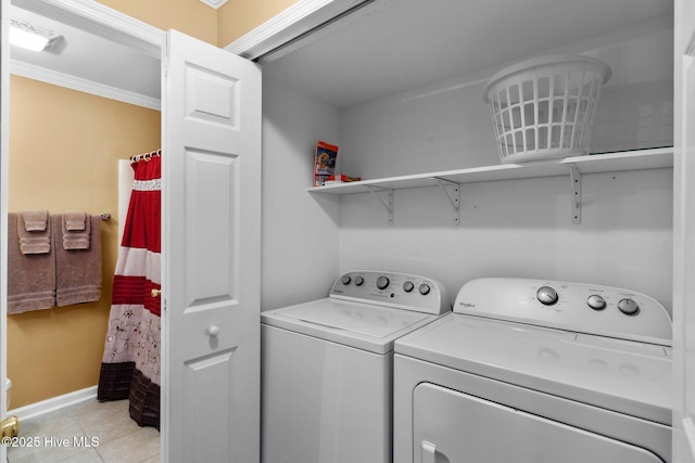 2714 W Beach Dr # 104, Oak Island, NC 28465 - laundry room featuring laundry area, ornamental molding, light tile patterned floors, baseboards, and washer and dryer