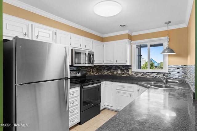 2714 W Beach Dr # 104, Oak Island, NC 28465 - kitchen featuring stainless steel appliances, a sink, dark countertops, white cabinetry, and decorative backsplash