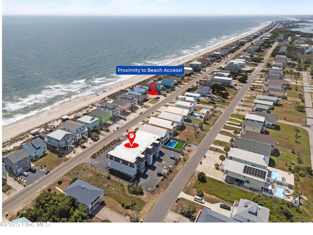 2714 W Beach Dr # 104, Oak Island, NC 28465 - drone / aerial view with a view of the beach and a water view