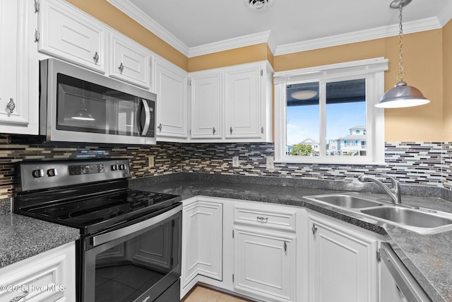 2714 W Beach Dr # 104, Oak Island, NC 28465 - kitchen with dark countertops, a sink, decorative backsplash, white cabinetry, and appliances with stainless steel finishes