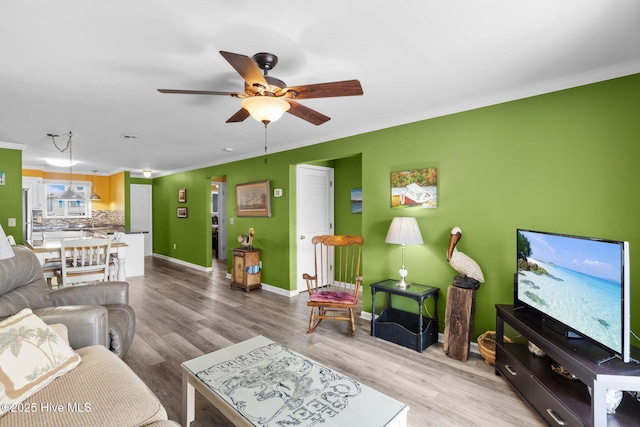 2714 W Beach Dr # 104, Oak Island, NC 28465 - living area with baseboards, a ceiling fan, wood finished floors, and crown molding