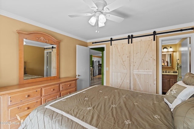 2714 W Beach Dr # 104, Oak Island, NC 28465 - bedroom with a barn door, a ceiling fan, ornamental molding, a sink, and ensuite bathroom