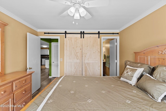 2714 W Beach Dr # 104, Oak Island, NC 28465 - bedroom with a barn door, wood finished floors, a ceiling fan, and ornamental molding