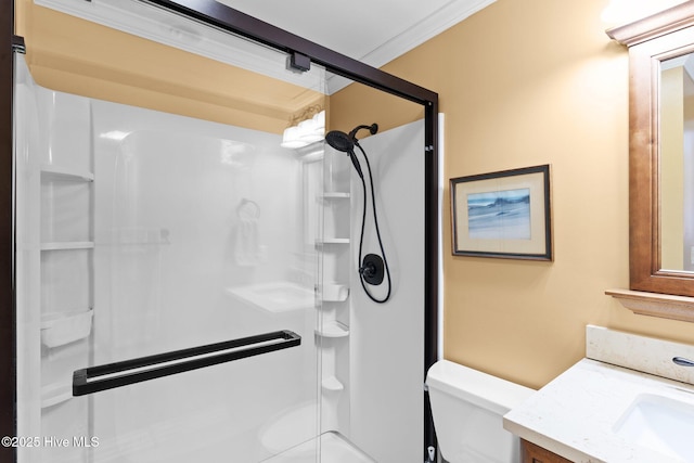 2714 W Beach Dr # 104, Oak Island, NC 28465 - bathroom featuring vanity, a shower stall, ornamental molding, and toilet