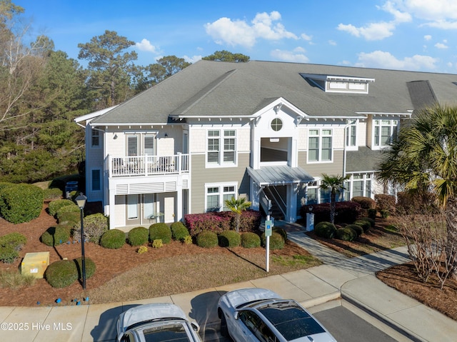 2537 St James Dr SE Apt 1003, Southport, NC 28461 - view of front of home with uncovered parking, roof with shingles, and a balcony
