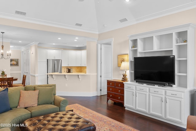 2537 St James Dr SE Apt 1003, Southport, NC 28461 - living area featuring dark wood-style floors, visible vents, crown molding, baseboards, and a chandelier