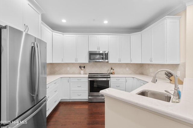 2537 St James Dr SE Apt 1003, Southport, NC 28461 - kitchen with white cabinets, appliances with stainless steel finishes, a sink, and dark wood-style floors
