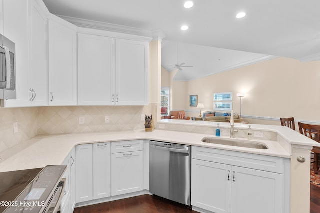 2537 St James Dr SE Apt 1003, Southport, NC 28461 - kitchen with white cabinets, a sink, a peninsula, appliances with stainless steel finishes, and ceiling fan