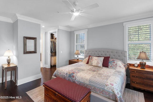 2537 St James Dr SE Apt 1003, Southport, NC 28461 - bedroom with a spacious closet, wood finished floors, ornamental molding, a closet, and baseboards