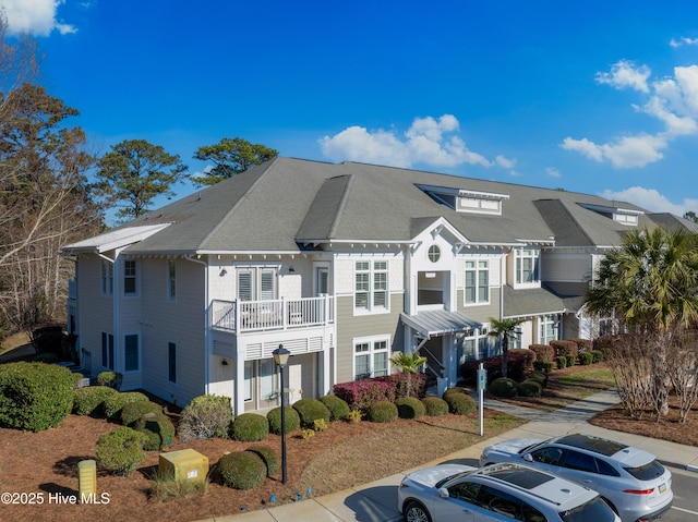 2537 St James Dr SE Apt 1003, Southport, NC 28461 - view of front of home featuring a balcony, uncovered parking, and a shingled roof