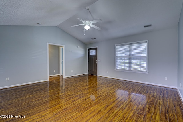 unfurnished living room with a ceiling fan, baseboards, wood finished floors, vaulted ceiling, and visible vents