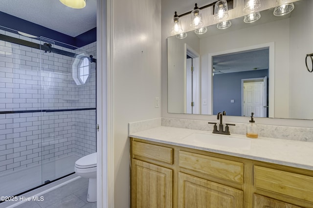 full bathroom featuring vanity, toilet, tile patterned flooring, and a stall shower