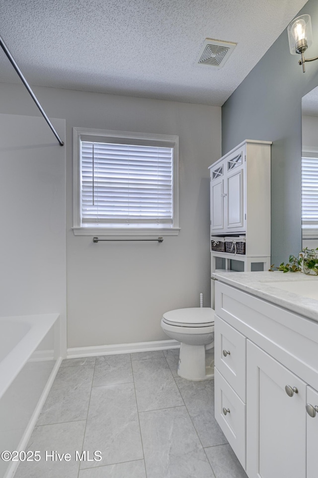 full bath with a textured ceiling, visible vents, vanity, baseboards, and toilet
