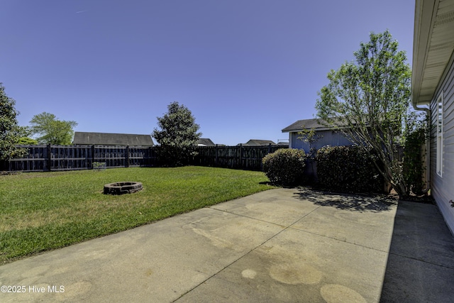 view of yard featuring a fenced backyard, a patio area, and an outdoor fire pit