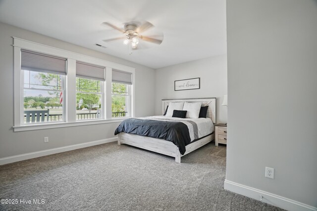 bedroom featuring carpet floors, baseboards, a ceiling fan, and visible vents