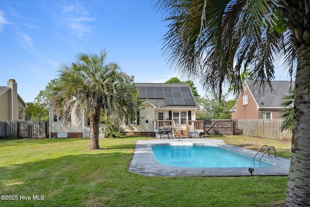view of pool featuring a yard, a deck, a fenced in pool, and a fenced backyard
