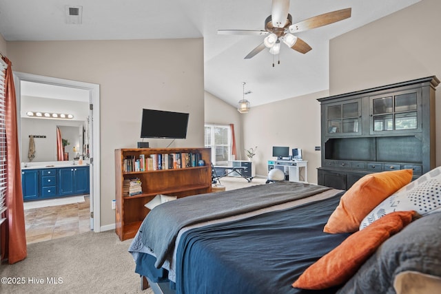 bedroom with baseboards, light carpet, connected bathroom, and lofted ceiling