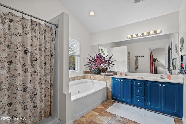 bathroom with a jetted tub, double vanity, lofted ceiling, and curtained shower