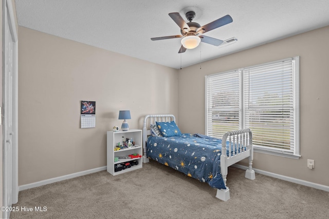 bedroom with baseboards, ceiling fan, carpet, and visible vents