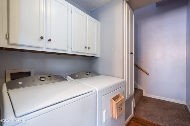 clothes washing area featuring baseboards, carpet flooring, cabinet space, and washing machine and clothes dryer