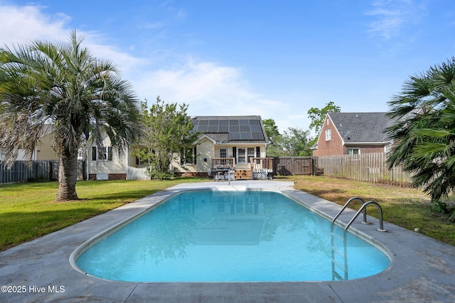 view of pool with a lawn, a deck, a fenced in pool, and a fenced backyard