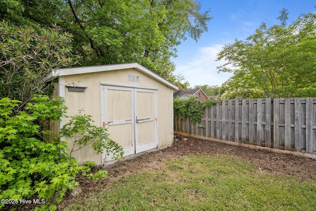 view of shed featuring fence