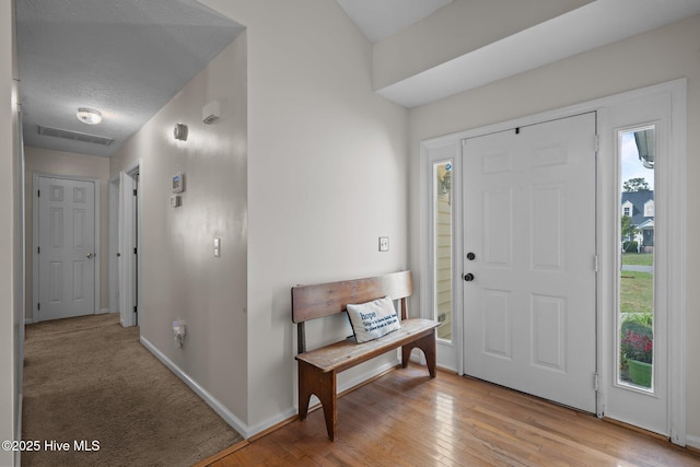 entryway featuring baseboards and light wood-style floors