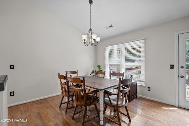 508 Commons Way, Wilmington, NC 28409 - dining space with a chandelier, light wood finished floors, and vaulted ceiling