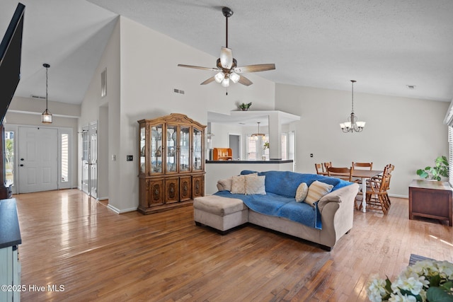 508 Commons Way, Wilmington, NC 28409 - living area featuring wood-type flooring, a ceiling fan, high vaulted ceiling, a chandelier, and a textured ceiling