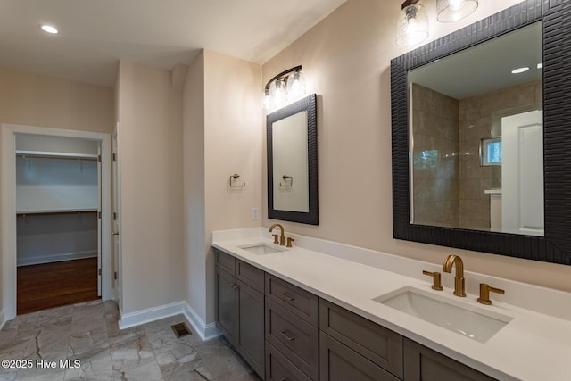 117 Banbridge Dr, West End, NC 27376 - full bathroom featuring baseboards, double vanity, a sink, and a walk in closet