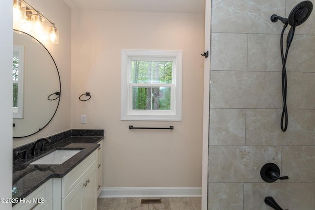 117 Banbridge Dr, West End, NC 27376 - bathroom featuring baseboards, a tile shower, vanity, and visible vents