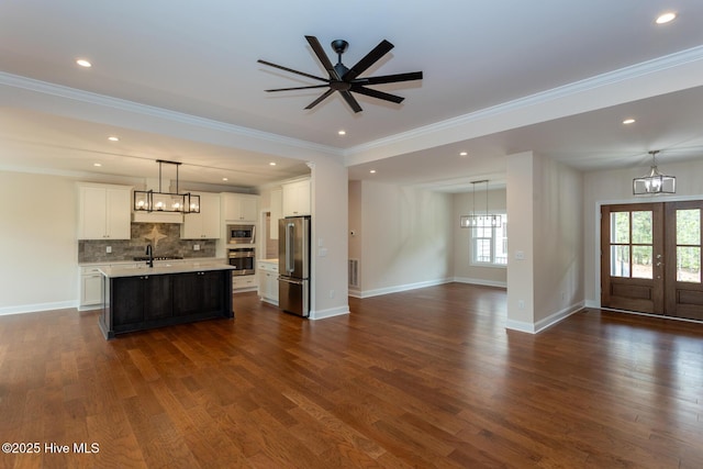 117 Banbridge Dr, West End, NC 27376 - kitchen featuring a sink, open floor plan, a chandelier, light countertops, and appliances with stainless steel finishes