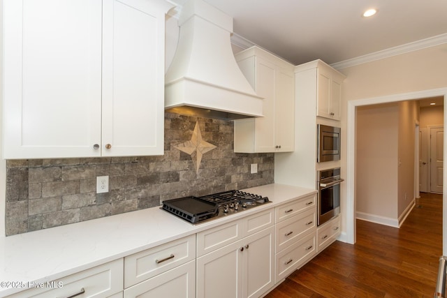 117 Banbridge Dr, West End, NC 27376 - kitchen with baseboards, ornamental molding, custom range hood, stainless steel appliances, and white cabinets