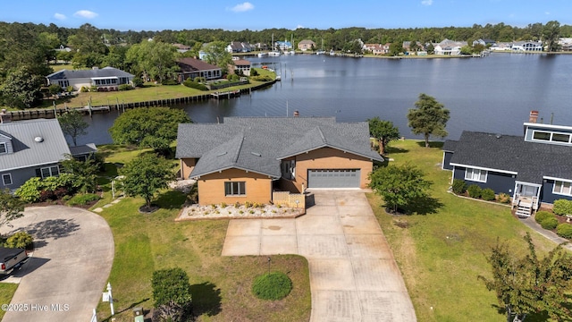 birds eye view of property with a water view and a residential view