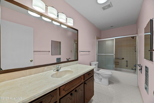 bathroom with tile patterned flooring, vanity, toilet, visible vents, and bath / shower combo with glass door