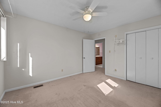 unfurnished bedroom with carpet floors, baseboards, a closet, and visible vents